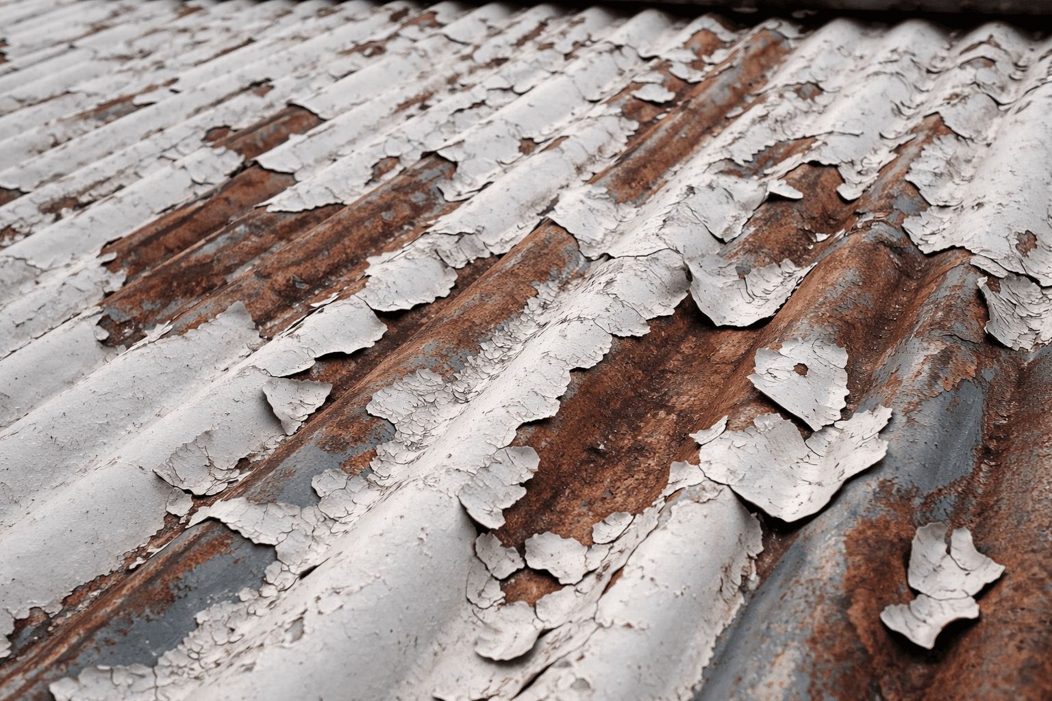 Interior ceiling showing damp patches and peeling paint from roof leaks in Stoke-on-Trent